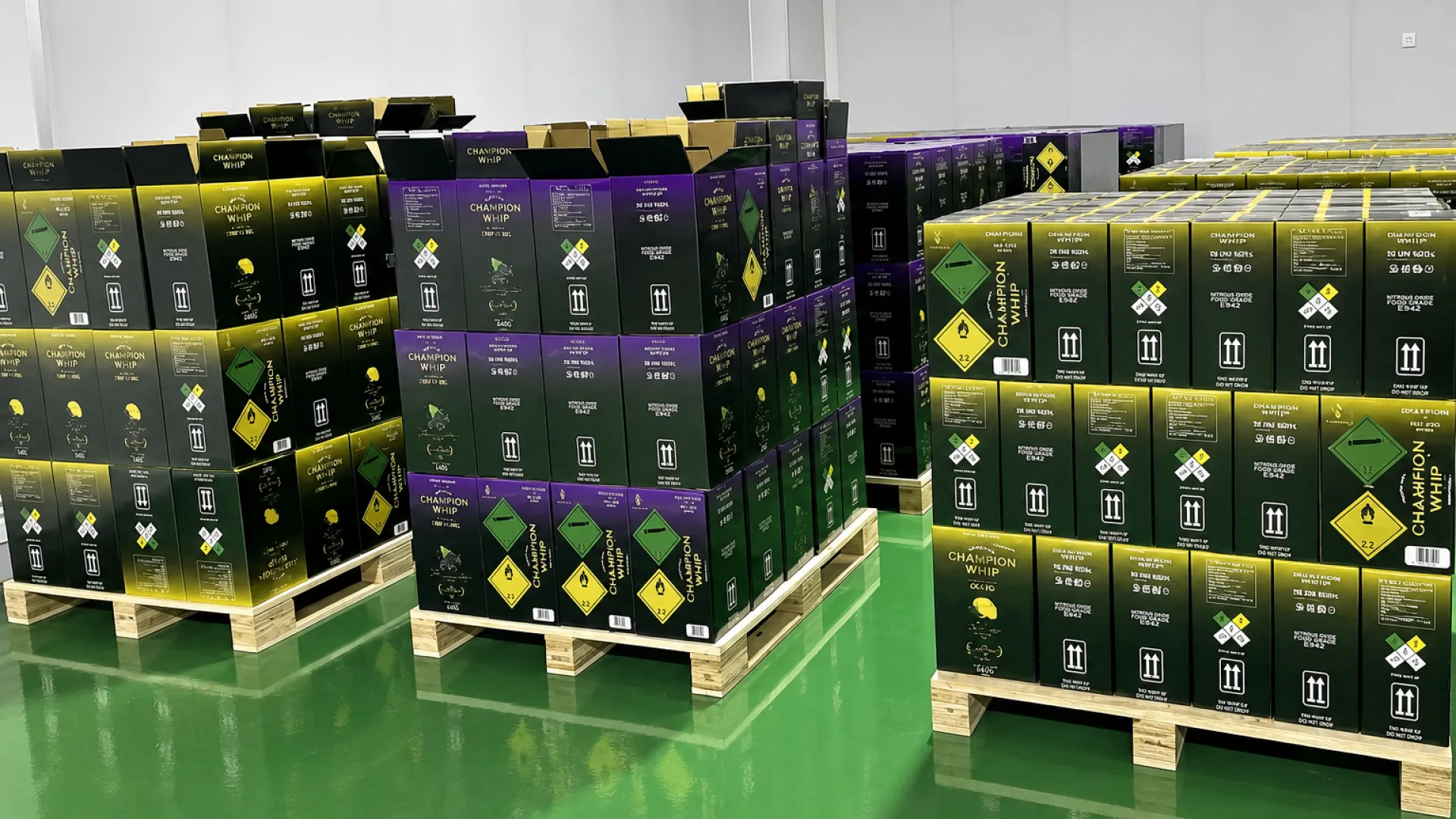 Cartons of bulk cream chargers stacked on a pallet in a warehouse